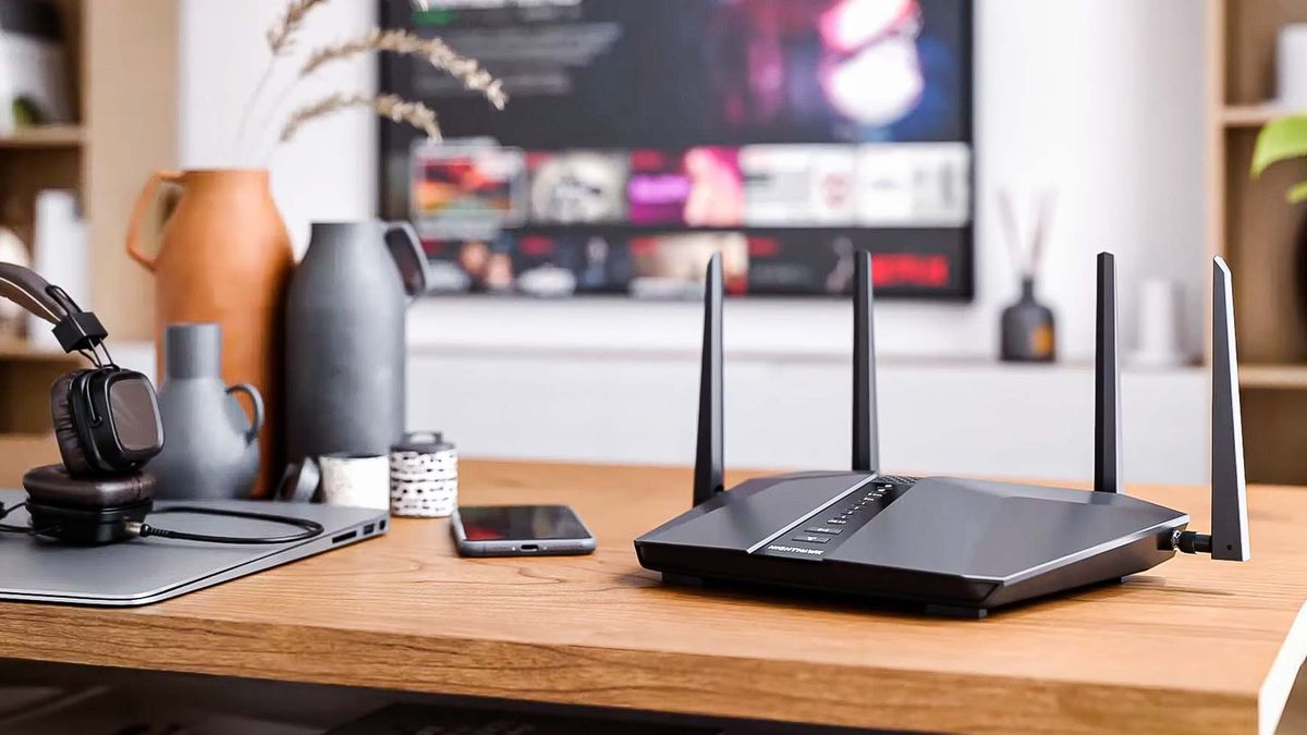 Modern black wifi router standing on desk in a bright living room